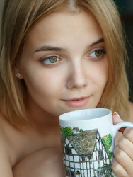 Stunning blonde Chanel Fenn sips her tea on the balcony
