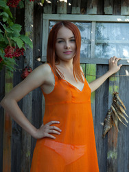 Sexy redhead Shaya lets her bright orange dress slip down to bare her gorgeous breasts